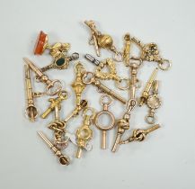 Twenty assorted mainly 19th century yellow metal small watch keys, including trade insignia,