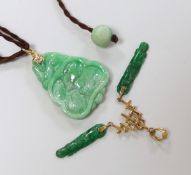 Two gold mounted jadeite pendants, largest 4.5cm long