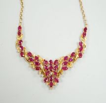 A 20th century Indian yellow metal, ruby and diamond chip cluster set necklace, with later 375