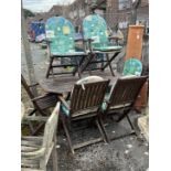 An octagonal stained teak folding garden table, length 150cm, depth 85cm, height 71cm and six