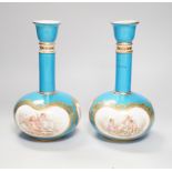 A pair of Coalport turquoise bottle vases, late 19th century, with putti and rose cartouche