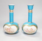 A pair of Coalport turquoise bottle vases, late 19th century, with putti and rose cartouche