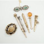 Four assorted early 20th century yellow or white metal overlaid propelling pencils, an agate set