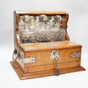 A Victorian three bottled oak nickel mounted tantalus,43cm high