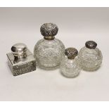 A George V silver mounted glass inkwell and three silver mounted cut glass scent bottles, largest
