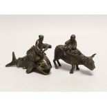 A Chinese parcel gilt metal model of a figure reading a scroll on a fish and one riding a buffalo,