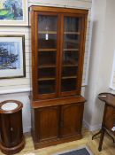A Victorian narrow mahogany bookcase cupboard, width 85cm, depth 40cm, height 207cm