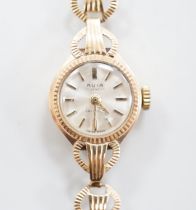 A lady's 9ct gold Avia manual wind wrist watch, on a 9ct gold bracelet, overall length 18cm, gross