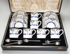A cased Royal Worcester ‘Orlando’ coffee set with silver spoons,