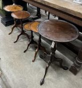 Five early 20th century and later circular mahogany and walnut tripod wine tables, largest