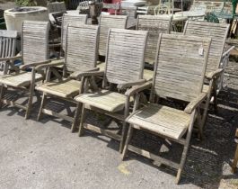 A set of eight weathered teak folding garden elbow chairs, width 60cm