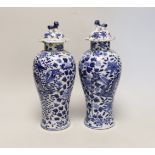 A pair of Chinese blue and white 'dragon’ vases and covers, Late 19th century, 29cm high