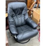 A mid century Scandinavian black leather reclining swivel armchair, width 74cm, depth 78cm, height