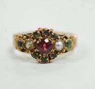 A late Victorian 15ct gold, ruby?, emerald and seed pearl cluster set dress ring, size K, gross