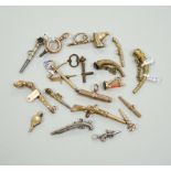 Eighteen assorted mainly 19th century base or yellow metal overlaid novelty watch keys, including