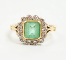 A modern 18ct gold, emerald and diamond set circular cluster ring, size O, gross weight 5 grams.