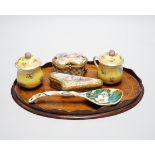 A small oval mahogany tray and German decorative porcelain cups and covers, two trinket boxes and