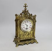 A Gothic style brass timepiece, 28cm tall, with key