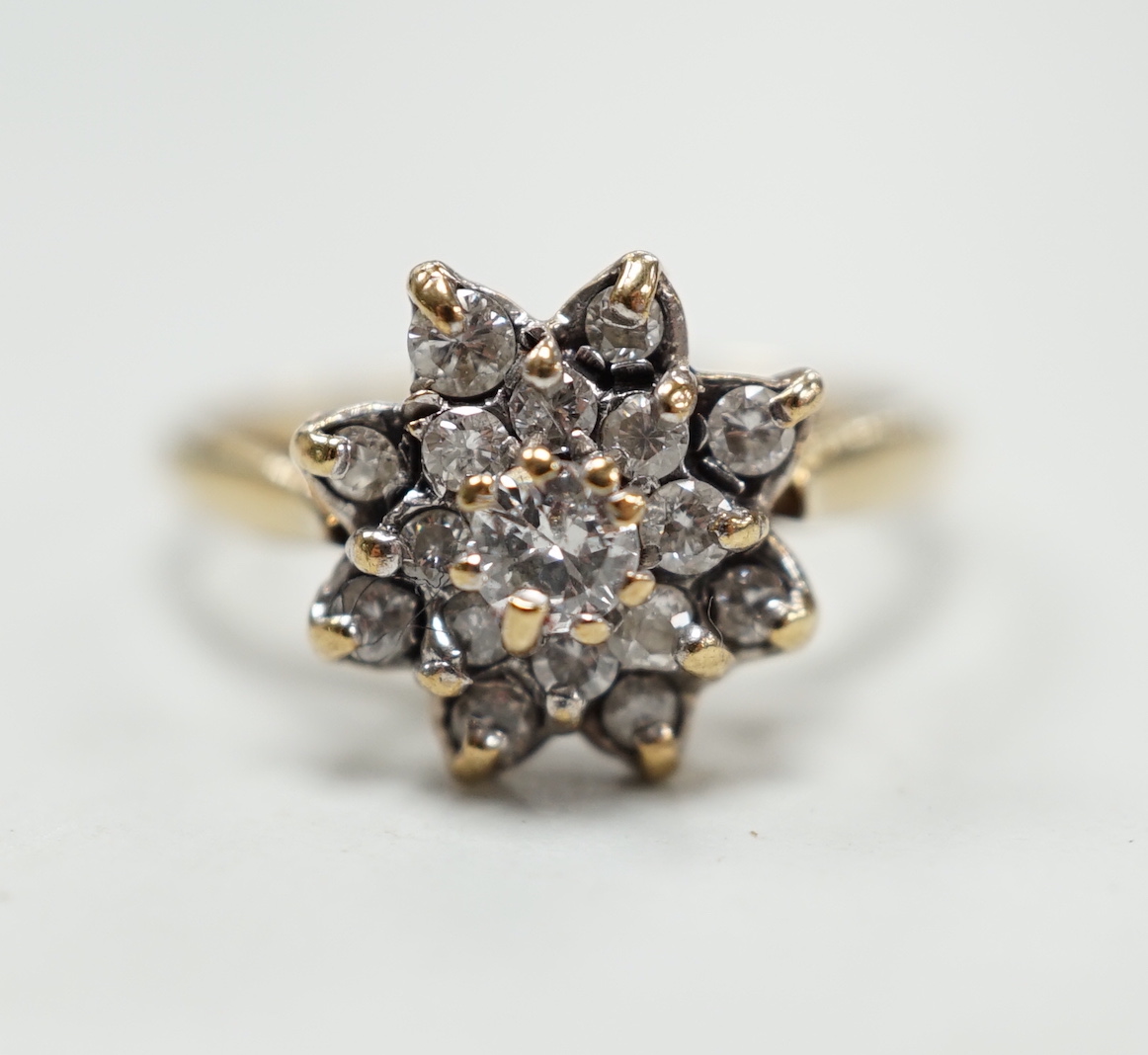 A modern 9ct gold and diamond cluster ring, size K/L, gross weight 3.1 grams.