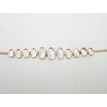A 9ct and graduated oval cut moonstone set bracelet, 16cm, gross weight 5 grams.