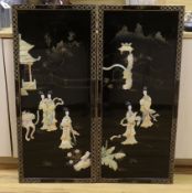 A pair of Chinese black lacquered panels, decorated in relief with females before pagodas, 92cm x