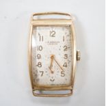 A gentleman's early 1950's 9ct gold J.W. Benson manual wind curved rectangular wrist watch, with