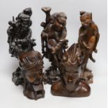 Three Chinese hardwood carvings of immortals and two African hardwood busts, tallest 38cm