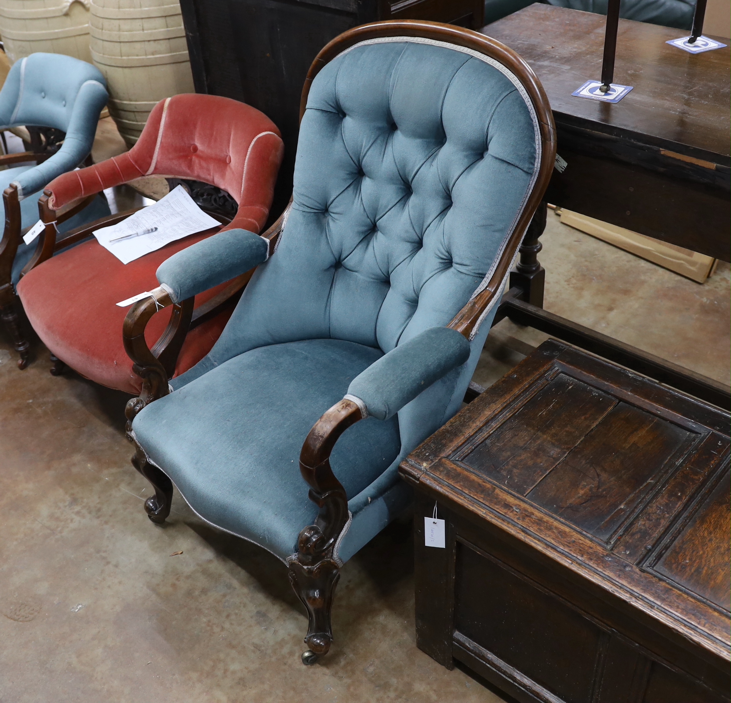 A late Victorian mahogany framed button back armchair, on cabriole legs, width 68cm, depth 72cm,