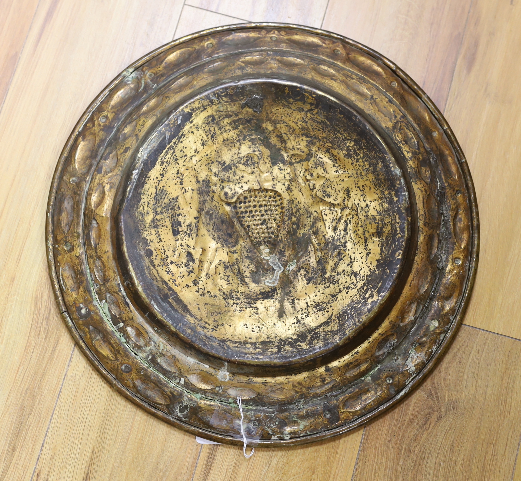 A brass Nuremberg Alms dish embossed with two figures, signed F Reimet Dreyers, 47cm in diameter - Image 2 of 2