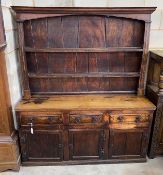 An 18th century provincial oak and elm dresser with associated boarded rack, length 163cm, depth