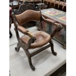 An early 20th century oak tan leather folding prayer chair, width 59cm, depth 62cm, height 90cm