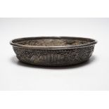 An Asian embossed white metal (tests as silver) shallow bowl, 25.2cm, 13.5oz.