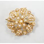 An Edwardian 15ct and seed pearl cluster set flower head brooch, 28mm, gross weight 6.3 grams.