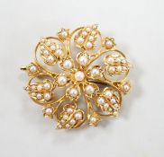 An Edwardian 15ct and seed pearl cluster set flower head brooch, 28mm, gross weight 6.3 grams.