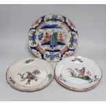 An 18th century Delft plate and three 19th century faience plates, largest 26cm diameter (4)