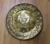 A brass Nuremberg Alms dish embossed with two figures, signed F Reimet Dreyers, 47cm in diameter