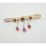 An early 20th century yellow metal, garnet and seed pearl cluster set drop bar brooch, 43mm, gross