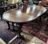 A 1920's Chippendale revival mahogany oval topped extending dining table, 238cm extended, two