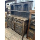 A 'Tudor Furniture' 17th century style carved oak dresser, width 146cm, depth 53cm, height 168cm