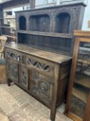 A 'Tudor Furniture' 17th century style carved oak dresser, width 146cm, depth 53cm, height 168cm