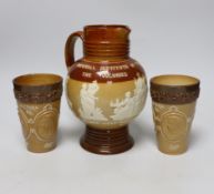 A Doulton stoneware jug and two tumblers, tallest 22cm