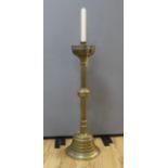 A large brass ecclesiastical candlestick with gothic border, 98cm high