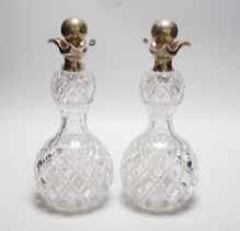 A pair of late Victorian silver mounted cut glass waisted tri-lipped decanters, with stoppers,