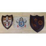 Three heraldic armorial shield shaped crests, one with Latin motto, In Deo Fidemus, the largest 24cm