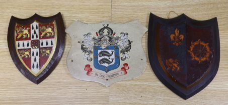 Three heraldic armorial shield shaped crests, one with Latin motto, In Deo Fidemus, the largest 24cm