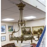 A gilt metal five branch chandelier, decorated with masks, 78cm high