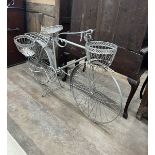 A wrought metal ' Bicycle' garden pot stand, length 144cm, height 90cm