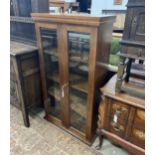 A South African mahogany glazed two door bookcase, width 75cm, depth 35cm, height 135cm