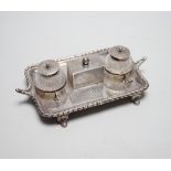 A late Victorian silver rectangular inkstand, with two mounted cut glass wells, central lidded