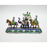 A 20th century Indian white metal and polychrome enamel figural group, with elephants and figures,